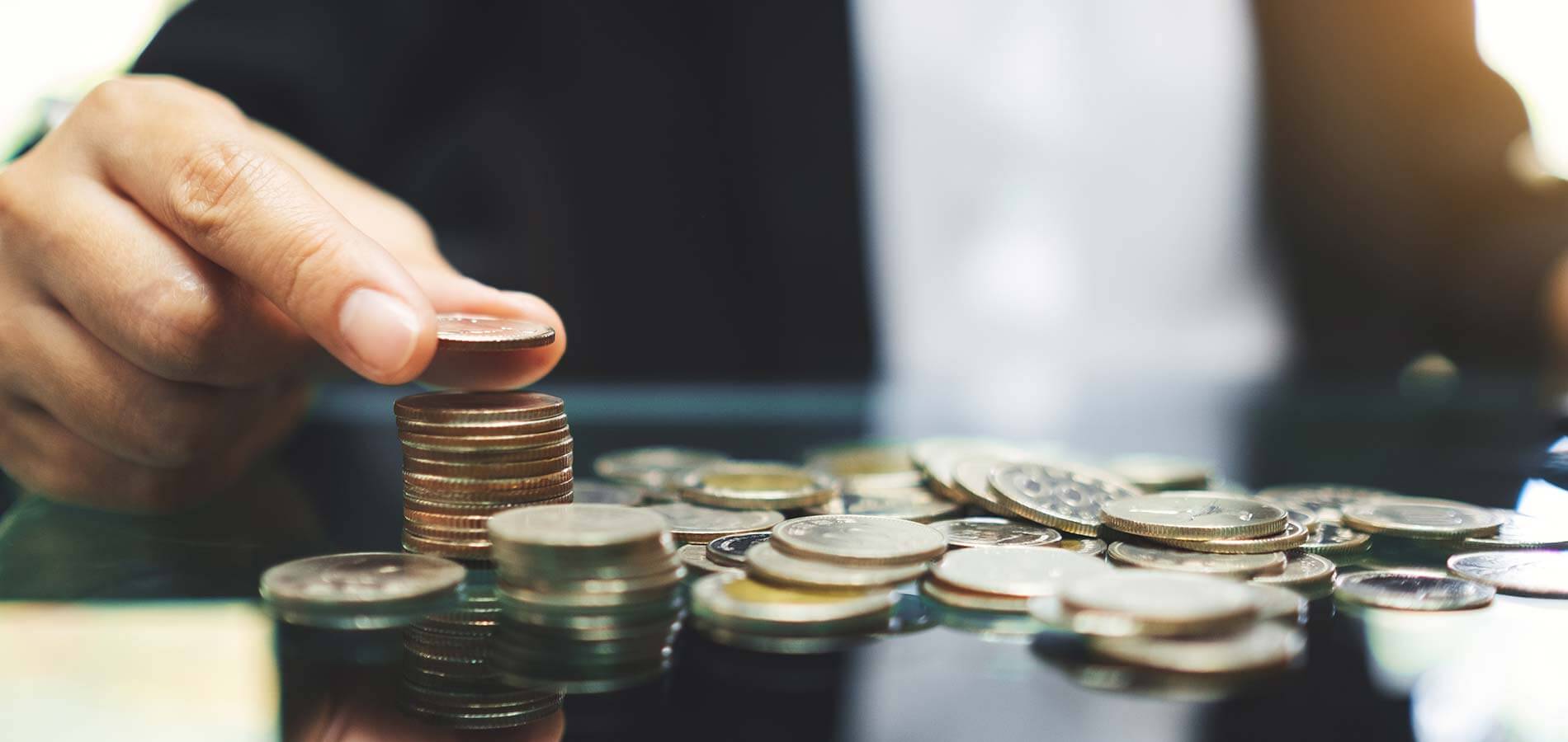 person stacking coins